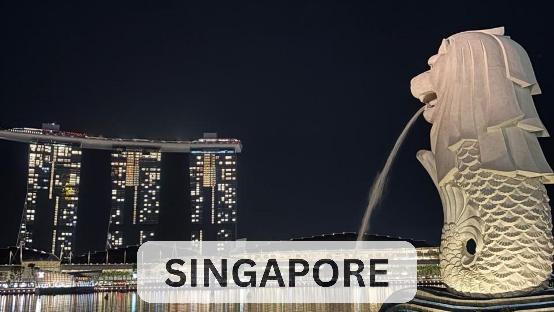 Merlion statue at night with Marina Bay Sands skyline illuminated in the background, Singapore